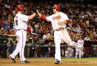 PHOENIX - AUGUST 10: Mark Reynolds #27 of the Arizona Diamondbacks celebrates at home plate with Chad Tracy #18 after scoring a run in the second inning against the New York Mets at Chase Field on August 10, 2009 in Phoenix, Arizona. (Photo by Christian Petersen/Getty Images)