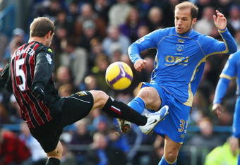 PORTSMOUTH, UNITED KINGDOM - FEBRUARY 14:  Angelos Basinas (R) of Portsmouth competes for the ball with Pablo Zabaleta (L) of Manchester City during the Barclays Premier League match between Portsmouth and Manchester City at Fratton Park on February 14, 2009 in London, England.  (Photo by Phil Cole/Getty Images)