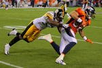 DENVER - NOVEMBER 09:  Tony Scheffler #88 of the Denver Broncos makes a reception and is tackled by Keyaron Fox #57 of the Pittsburgh Steelers during NFL action at Invesco Field at Mile High on November 9, 2009 in Denver, Colorado. The Steelers defeated the Broncos 28-10.  (Photo by Doug Pensinger/Getty Images)