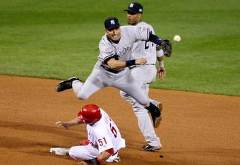 PHILADELPHIA - NOVEMBER 02:  Derek Jeter #2 of the New York Yankees turns a successful double play over Carlos Ruiz #51 in the bottom of the eighth inning against the Philadelphia Phillies in Game Five of the 2009 MLB World Series at Citizens Bank Park on November 2, 2009 in Philadelphia, Pennsylvania.  (Photo by Al Bello/Getty Images)