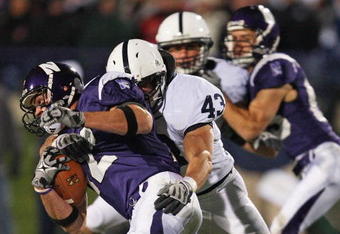 EVANSTON, IL - OCTOBER 31: Andrew Brewer #12 of the Northwestern Wildcats is tackled by Josh Hull #43 of the Penn State Nittany Lions at Ryan Field on October 31, 2009 in Evanston, Illinois. Penn State defeated Northwestern 34-13. (Photo by Jonathan Daniel/Getty Images)
