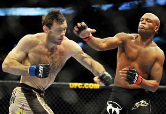PHILADELPHIA - AUGUST 08:  Anderson Silva (R) throws a right punch to Forrest Griffin during their light heavyweight bout at UFC 101: Declaration at the Wachovia Center on August 8, 2009 in Philadelphia, Pennsylvania.  (Photo by Jon Kopaloff/Getty Images)