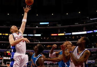 LOS ANGELES, CA - NOVEMBER 09:  Chris Kaman #35 of the Los Angeles Clippers shoots over Emeka Okafor #50 of the New Orleans Hornets in the first half at Staples Center on November 9, 2009 in Los Angeles, California. The Hornets defeated the Clippers 112-84. NOTE TO USER: User expressly acknowledges and agrees that, by downloading and/or using this Photograph, user is consenting to the terms and conditions of the Getty Images License Agreement.  (Photo by Jeff Gross/Getty Images)