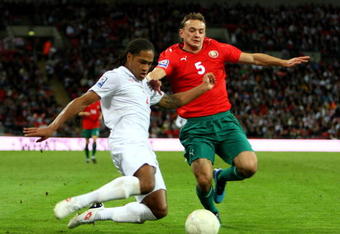 LONDON, ENGLAND - OCTOBER 14:  Glen Johnson of England tackles Aleksandr Yurevich of Belarus during the FIFA 2010 World Cup Qualifying Group 6 match between England and Belarus at Wembley Stadium on October 14, 2009 in London, England.  (Photo by Phil Cole/Getty Images)