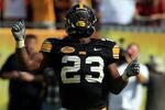 TAMPA, FL - JANUARY 01:  Shonn Green #23 of the Iowa Hawkeyes celebrates a touchdown run against the South Carolina Gamecocks during the Outback Bowl on January 1, 2009 at Raymond James Stadium in Tampa, Florida.  (Photo by Scott Halleran/Getty Images)