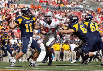 CLEVELAND - SEPTEMBER 19: Nathan Williams #43 of the Ohio State Buckeyes rushes quarterback Aaron Opelt #11 of the Toledo Rockets at Cleveland Browns Stadium on September 19, 2009 in Cleveland, Ohio. The Ohio State Buckeyes shutout the Toledo Rockets 38-0. (Photo by Gregory Shamus/Getty Images)
