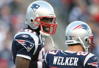 FOXBORO, MA - NOVEMBER 8:  Randy Moss #81 of the New England Patriots reacts with teammate Wes Welker #83 during a game against the Miami Dolphins at Gillette Stadium on November 8, 2009 in Foxboro, Massachusetts. The Patriots won 27-17. (Photo by Jim Rogash/Getty Images)