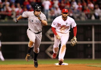 PHILADELPHIA - NOVEMBER 01:  Johnny Damon #18 (L) of the New York Yankees advances to third base after he stole second base in the top of the ninth inning against Pedro Feliz #7 of the Philadelphia Phillies in Game Four of the 2009 MLB World Series at Citizens Bank Park on November 1, 2009 in Philadelphia, Pennsylvania.  (Photo by Al Bello/Getty Images)