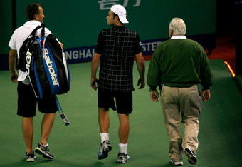 SHANGHAI, CHINA - OCTOBER 13: Andy Roddick of the United States leaves the court with ATP trainer Michael Novotny and ATP Supervisor Tom Barnes after retiring from his match against Stanilas Wawrinka of Switzerland on day three of the 2009 Shanghai ATP Masters 1000 at Qi Zhong Tennis Centre on October 13, 2009 in  (Photo by Matthew Stockman/Getty Images)