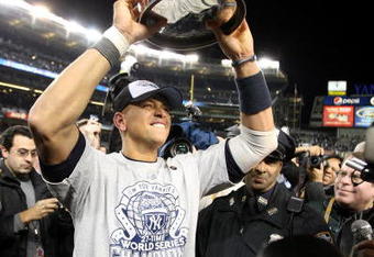 NEW YORK - NOVEMBER 04:  Alex Rodriguez #13 of the New York Yankees celebrates with the trophy after their 7-3 win  against the Philadelphia Phillies in Game Six of the 2009 MLB World Series at Yankee Stadium on November 4, 2009 in the Bronx borough of New York City.  (Photo by Jed Jacobsohn/Getty Images)
