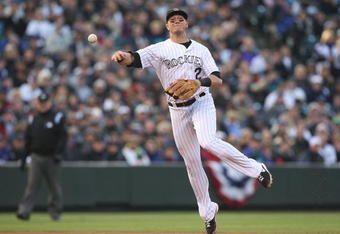 DENVER - OCTOBER 11:  Troy Tulowitzki #2 of the Colorado Rockies throws out Pedro Feliz of the Philadelphia Phillies in the top of the fourth inning in Game Four of the NLDS during the 2009 MLB Playoffs at Coors Field on October 12, 2009 in Denver, Colorado.  (Photo by Jed Jacobsohn/Getty Images)