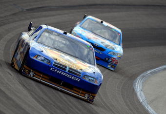 FORT WORTH, TX - NOVEMBER 08:  Kurt Busch, driver of the #2 Miller Lite Dodge, races Marcos Ambrose, driver of the #47 Little Debbie/Kingsford/Clorox Toyota, during the NASCAR Sprint Cup Series Dickies 500 at Texas Motor Speedway on November 8, 2009 in Fort Worth, Texas.  (Photo by Robert Laberge/Getty Images for NASCAR)