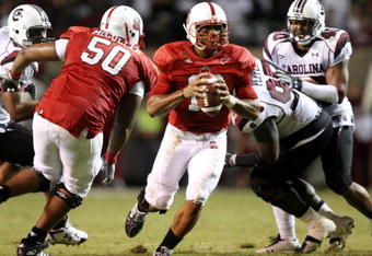 RALEIGH, NC - SEPTEMBER 3:  Quarterback Russell Wilson #16 of the North Carolina State Wolfpack drops back to pass with protection by Jeraill McCuller #50 against the South Carolina Gamecocks during the game at Carter-Finley Stadium on September 3, 2009 in Raleigh, North Carolina. (Photo by Streeter Lecka/Getty Images)