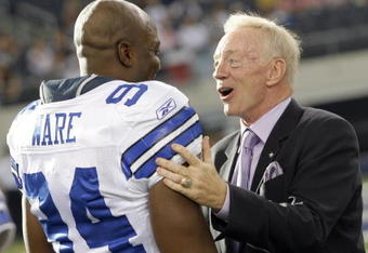 ARLINGTON, TX - AUGUST 21:  Dallas Cowboys team owner Jerry Jones talks with linebacker DeMarcus Ware #94 prior to the Cowboys taking the field against the Tennessee Titans during a preseason game at Cowboys Stadium on August 21, 2009 in Arlington, Texas. (Photo by Tom Pennington/Getty Images)