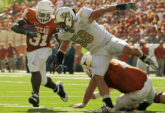 AUSTIN, TX - NOVEMBER 07:  Running back Cody Johnson #31 of the Texas Longhorns runs with the ball against linebacker Cory Hogue #59 of the UCF Knights on November 7, 2009 at Darrell K Royal - Texas Memorial Stadium in Austin, Texas.  Texas won 35-3.  (Photo by Brian Bahr/Getty Images)