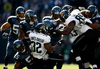 SEATTLE, WA - OCTOBER 11:  The defense of the Seattle Seahawks stops Maurice Jones-Drew #32 of the Jacksonville Jaguars at Qwest Field on October 11, 2009 in Seattle, Washington.  (Photo by Jonathan Ferrey/Getty Images)