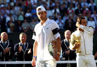 WIMBLEDON, ENGLAND - JULY 05:  Andy Roddick of USA looks despondent after defeat during the men's singles final match against Roger Federer of Switzerland on Day Thirteen of the Wimbledon Lawn Tennis Championships at the All England Lawn Tennis and Croquet Club on July 5, 2009 in London, England. Federer won 5-7, 7-6, 7-6, 3-6, 16-14.  (Photo by Clive Brunskill/Getty Images)