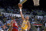 1989: Kareem Abdul- Jabbar of the Los Angeles Lakers makes a layup as Benoit Benjamin of the LA Clippers tries to block him.  Mandatory Credit: Stephen Dunn  /Allsport