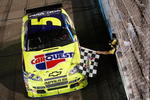 AVONDALE, AZ - APRIL 18:  Mark Martin, driver of the #5 CARQUEST/Kellogg's Chevrolet, receives the checkered flag from NASCAR Official Rodney Wise after winning the NASCAR Sprint Cup Series SUBWAY Fresh Fit 500 at Phoenix International Raceway on April 18, 2009 in Avondale, AZ.  (Photo by Chris Graythen/Getty Images for NASCAR)