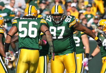GREEN BAY, WI - OCTOBER 18: Johnny Jolly #97 and  Nick Barnett #56 of the Green Bay Packers celebrate a defensive stop against the Detroit Lions at Lambeau Field on October 18, 2009 in Green Bay, Wisconsin. The Packers defeated the Lions 26-0. (Photo by Jonathan Daniel/Getty Images)