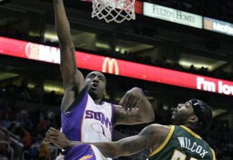 PHOENIX - FEBRUARY 8:  Amare' Stoudemire #1 of the Phoenix Suns lays the ball in against Chris Wilcox #54 of the Seattle SuperSonics on February 8, 2008 at US Airways Center in Phoenix, Arizona. NOTE TO USER: User expressly acknowledges and agrees that, by downloading and or using this Photograph, user is consenting to the terms and conditions of the Getty Images License Agreement.(Photo by Domenic Centofanti/Getty Images)