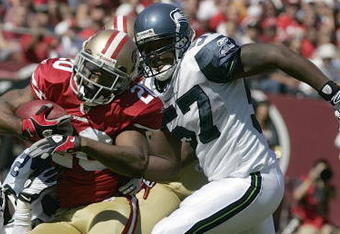 SAN FRANCISCO - SEPTEMBER 20:  Cornerback Allen Rossum #20 of the San Francisco 49ers tries to break a tackle by cornerback Kelly Jennings #21 and linebacker David Hawthorne #57 of the Seattle Seahawks in the first quarter action during the home opener at Candlestick Park on September 20, 2009 in San Francisco, California.  (Photo by David Paul Morris/Getty Images)