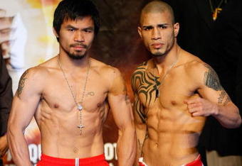 LAS VEGAS - NOVEMBER 13:  Manny Pacquiao (L) and WBO welterweight champion Miguel Cotto stand next to each other during the weigh-in for their bout at the MGM Grand Garden Arena on November 13, 2009 in Las Vegas, Nevada. Pacquiao and Cotto will meet in a WBO welterweight title fight at the MGM Grand on November 14.  Pacquiao weighed in at 144 pounds and Cotto weighed in at 145 pounds.  (Photo by Ethan Miller/Getty Images)