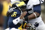 ANN ARBOR, MI - OCTOBER 24:  Denard Robinson #16 of the Michigan Wolverines is tackled by Bani Gbadyu #15 and Josh Hull #43 of the Penn State Nittany Lions on October 24, 2009 at Michigan Stadium in Ann Arbor, Michigan.  (Photo by Gregory Shamus/Getty Images)