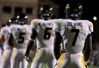BOULDER, CO - SEPTEMBER 18:  Quarterback Pat White #5 of the West Virginia Mountaineers along with Will Johnson #6 and Noel Devine #7 line up in the back field against the Colorado Buffaloes at Folsom Field on September 18, 2008 in Boulder, Colorado. Colorado defeated West Virginia 17-14 in overtime.  (Photo by Doug Pensinger/Getty Images)