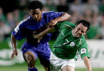 DUBLIN, IRELAND - SEPTEMBER 7: Republic of Ireland winger Andy Reid tussles with French player Florent Malouda during the World Cup Group 4 Qualifying Match between Ireland and France at Lansdowne Road on September 7, 2005 in Dublin, Ireland/ (Photo by Stu Forster/Getty Images)