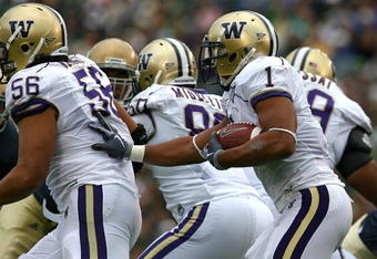 SOUTH BEND, IN - OCTOBER 03: Chris Polk #1 of the Washington Huskies follows blocker Senio Kelemete #56 against the Notre Dame Fighting Irish on October 3, 2009 at Notre Dame Stadium in South Bend, Indiana. Notre Dame defeated Washington 37-30 in overtime. (Photo by Jonathan Daniel/Getty Images)
