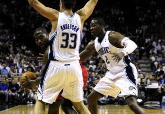 ORLANDO, FL - OCTOBER 28:  Elton Brand #42 of the Philadelphia 76ers looks for an open pass around Ryan Anderson #33 and Mickael Pietrus #20 of the Orlando Magic during the game on October 28, 2009 at Amway Arena in Orlando, Florida.  NOTE TO USER: User expressly acknowledges and agrees that, by downloading and/or using this Photograph, user is consenting to the terms and conditions of the Getty Images License Agreement.  (Photo by Sam Greenwood/Getty Images)