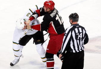 GLENDALE, AZ - NOVEMBER 14:  Paul Bissonnette #12 of the Phoenix Coyotes lands a punch to the head of Krystofer Barch #13 of the Dallas Stars in the second period at Jobing.com Arena on November 14, 2009 in Glendale, Arizona.  (Photo by Jeff Gross/Getty Images)
