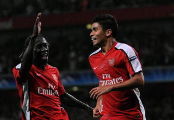 LONDON, ENGLAND - AUGUST 26:  Eduardo of Arsenal is congratulated by teammate Bacary Sagna (L) after scoring the opening goal from the penalty spot during the UEFA Champions League 2nd qualifying round 2nd leg match between Arsenal and Celtic at the Emirates Stadium on August 26, 2009 in London, England.  (Photo by Shaun Botterill/Getty Images)