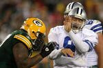 GREEN BAY, WI - NOVEMBER 15: Tony Romo #9 of the Dallas Cowboys closes his eyes as he is hit by Johnny Jolly #97 of the Green Bay Packers at Lambeau Field on November 15, 2009 in Green Bay, Wisconsin. The Packers defeated the Cowboys 17-7.  (Photo by Jonathan Daniel/Getty Images)