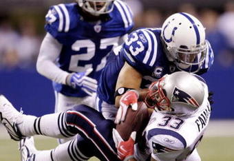 INDIANAPOLIS - NOVEMBER 15:  Melvin Bullitt #33 of the Indianapolis Colts tackles Kevin Faulk #33 of the New England Patriots short of a first down to gain possesion late in the fourth quarter of the game at Lucas Oil Stadium on November 15, 2009 in Indianapolis, Indiana. The Colts won the 35-34. (Photo by Jamie Squire/Getty Images)