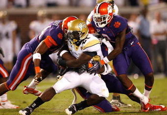 ATLANTA - SEPTEMBER 10:  Running back Jonathan Dwyer #21 of the Georgia Tech Yellow Jackets rushes upfield against Scotty Cooper #44, Andre Branch #40 and DeAndre McDaniel #2 of the Clemson Tigers at Bobby Dodd Stadium on September 10, 2009 in Atlanta, Georgia.  (Photo by Kevin C. Cox/Getty Images)