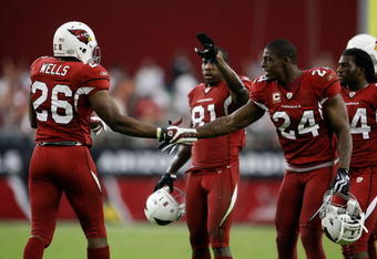 GLENDALE, AZ - NOVEMBER 15:  Beanie Wells #26 of the Arizona Cardinals celebrates a touchdown with Adrian Wilson #24 in the second half against the Seattle Seahawks at University of Phoenix Stadium on November 15, 2009 in Glendale, Arizona. The Cardinals defeated the Seahawks 31-20.  (Photo by Jeff Gross/Getty Images)