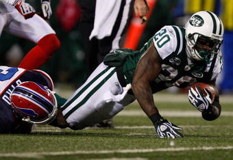 EAST RUTHERFORD, NJ - OCTOBER 18: Thomas Jones #20 of the New York Jets is tackled after a run by Jairus Byrd #31 of the Buffalo Bills during the game on October 18, 2009 at Giants Stadium in East Rutherford, New Jersey. The Bills defeated the Jets 16-13 in overtime. (Photo by Jared Wickerham/Getty Images)
