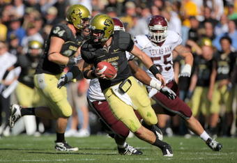BOULDER, CO - NOVEMBER 07:  Quarterback Tyler Hansen #9 of the Colorado Buffaloes rolls out to deliver a pass against the Texas A&M Aggies during NCAA college football action at Folsom Field on November 7, 2009 in Boulder, Colorado. Colorado defeated Texas A&M 35-34.  (Photo by Doug Pensinger/Getty Images)