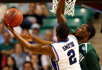GREENSBORO, NC - MARCH 19:  Nolan Smith #2 of the Duke Blue Devils lays in a basket against Kyrie Sutton #33 of the Binghamton Bearcats during the first round of the NCAA Division I Men's Basketball Tournament at the Greensboro Coliseum on March 19, 2009 in Greensboro, North Carolina.  (Photo by Streeter Lecka/Getty Images)