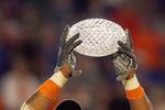 MIAMI - JANUARY 08:  Brandon Spikes #51 of the Florida Gators holds up the winning trophy after the FedEx BCS National Championship Game against the Oklahoma Sooners at Dolphin Stadium on January 8, 2009 in Miami, Florida.  (Photo by Eliot J. Schechter/Getty Images)