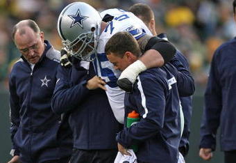 GREEN BAY, WI - NOVEMBER 15: Marc Colombo #75 of the Dallas Cowboys is helped off the field after an injury against the Green Bay Packers at Lambeau Field on November 15, 2009 in Green Bay, Wisconsin. (Photo by Jonathan Daniel/Getty Images)