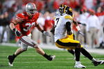 COLUMBUS, OH - NOVEMBER 14:  Linebacker Austin Spitler #38 of the Ohio State Buckeyes tackles wide receiver Marvin McNutt #7 of the Iowa Hawkeyes at Ohio Stadium on November 14, 2009 in Columbus, Ohio.  (Photo by Jamie Sabau/Getty Images)