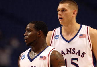 MINNEAPOLIS - MARCH 20:  (L-R) Sherron Collins #4 and Cole Aldrich #45 of the Kansas Jayhawks look on against the North Dakota State Bison during the first round of the NCAA Division I Men's Basketball Tournament at the Hubert H. Humphrey Metrodome on March 20, 2009 in Minneapolis, Minnesota. Kansas won 84-74. (Photo by Jonathan Daniel/Getty Images)