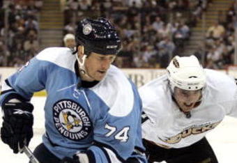 PITTSBURGH, PA - NOVEMBER 16:  Jay McKee #74 of the Pittsburgh Penguins and Joffrey Lupul #14 of the Anaheim Ducks battle for a loose puck in the second period at Mellon Arena on November 16, 2009 in Pittsburgh, Pennsylvania.  (Photo by Justin K. Aller/Getty Images)