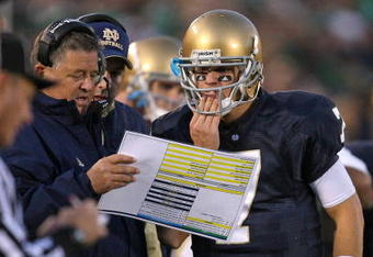 SOUTH BEND, IN - OCTOBER 17: Head coach Charlie Weis of the Notre Dame Fighting Irish gives a play to quarterback Jimmy Clausen #7 during a game against the USC Trojans at Notre Dame Stadium on October 17, 2009 in South Bend, Indiana. USC defeated Notre Dame 34-27. (Photo by Jonathan Daniel/Getty Images)