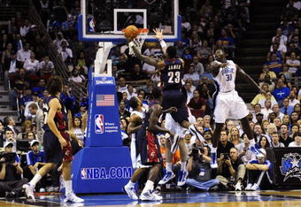 ORLANDO, FL - NOVEMBER 11:  LeBron James #23 of the Cleveland Cavaliers goes to the basket against Brandon Bass #30 of the Orlando Magic during the game on November 11, 2009 at Amway Arena in Orlando, Florida. NOTE TO USER: User expressly acknowledges and agrees that, by downloading and/or using this Photograph, user is consenting to the terms and conditions of the Getty Images License Agreement. (Photo by Sam Greenwood/Getty Images)