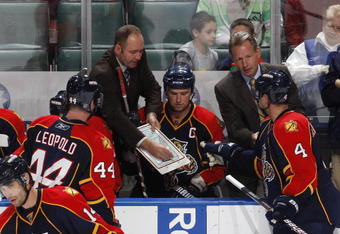 SUNRISE, FL - NOVEMBER 16: Head coach Peter DeBoer of the Florida Panthers goes over a play with Dennis Seidenberg #4 and Jordan Leopold #44 during th eovertime period against the Los Angeles Kings on November 16, 2009 at the BankAtlantic Center in Sunrise, Florida. The Kings defeated the Panthers 4-3. (Photo by Joel Auerbach/Getty Images)