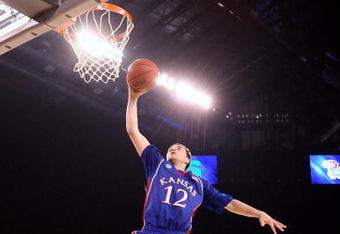 INDIANAPOLIS - MARCH 27:  Brady Morningstar #12 of the Kansas Jayhawks dunks against the Michigan State Spartans during the third round of the NCAA Division I Men's Basketball Tournament at the Lucas Oil Stadium on March 27, 2009 in Indianapolis, Indiana.  (Photo by Andy Lyons/Getty Images)